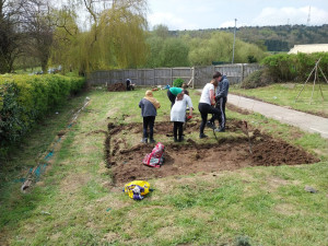 A group of students digging out a patch of grass