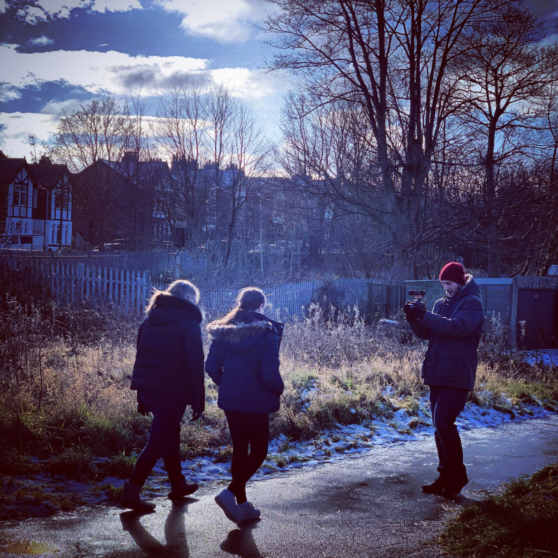 Young people being filmed walking by photographer
