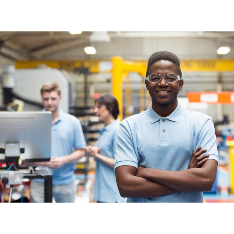 Man wearing protective glasses in engineering workshop.