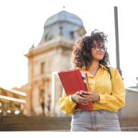Female student smiling and holding school books.