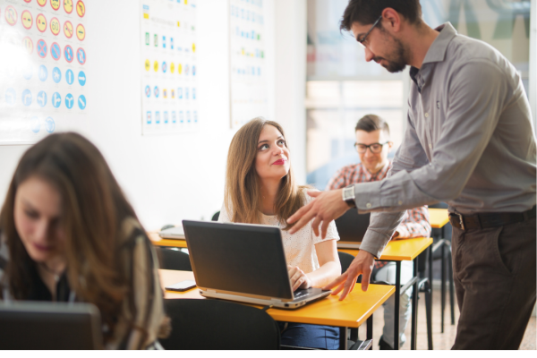 Teacher helping student